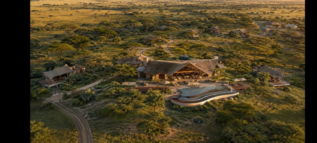 Aerial view of a remote safari lodge in a savanna setting at dusk
